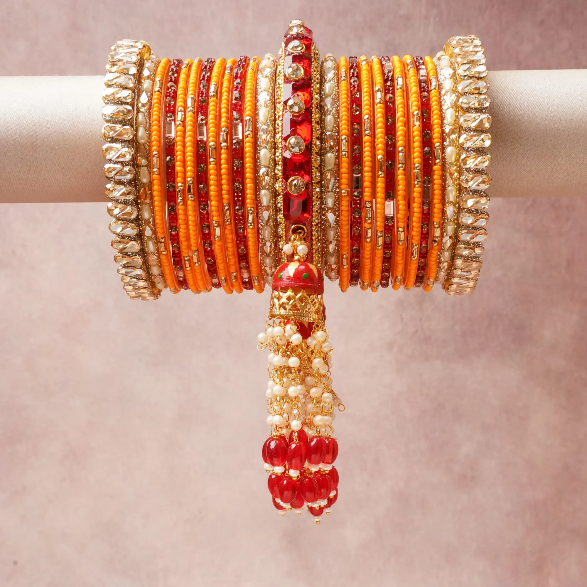 A commanding Apricot Orange anchors this beautiful set, enriched with accents of Crimson Red, Metallic Gold, Clear Crystal that add depth and dimension.

Featuring a striking composition of Gold-toned Metal Alloy, Lac Resin, Glass Beads, Mirrored Glass, Faux Pearls, Glass Rhinestones, this set carries intricate craftsmanship and strong presence. Grand in form, it is created for moments that deserve to be marked.